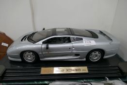 1/12th scale die cast model of jaguar XK220 by Maisto and a boxed die cast model of Mclaren F1, on a