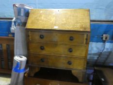 An oak bureau and chest of drawers both having three drawers