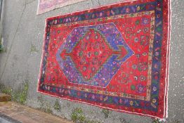 A Hamadan style rug having central motif, blue bordered 222cm x 150cm