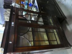 An Edwardian inlaid mahogany display cabinet having two lower drawers