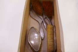 A silver engine turned dressing table set comprising of brushes and a hand mirror hallmarked Birming
