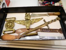 A trench art style souvenir dagger, other similar daggers, a brass military 2 piece belt buckle and