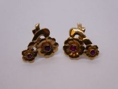 A pair of ruby set yellow metal floral design earrings, unmarked, 2.6g approx