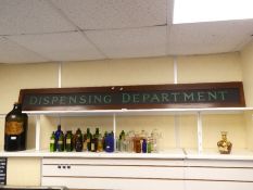 A large oblong sign in wooden frame "Dispensing Department", 223cm