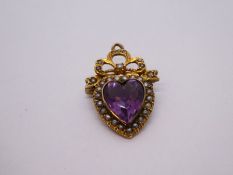 Unmarked yellow metal pendant brooch with heart shaped amethyst surrounded seed pearls, 2.5cm length