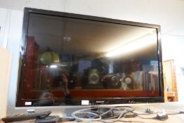 A Panasonic flat screen TV with remote