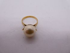 Yellow metal dress ring set with large simulated pearl, marks to outer ring illegible, size L/M, 3.5