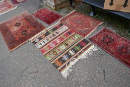 A small Afghan rug, a kilim rug and three others