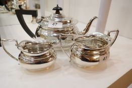 A silver three piece tea service comprising of a teapot, two handled sugar bowl and a milk jug. Hall