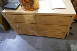 A modern veneered chest having six drawers