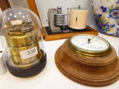 A Negretti & Zambra circular barometer and a modern German weather centre