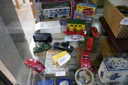 Selection of small unboxed Dinky cars and a garage, plus three Matchbox cars in boxes