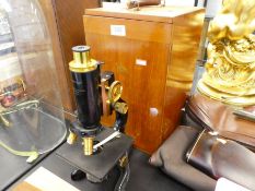 A 1940s microscope in fitted mahogany case by W. Watson "Service Model" with additional slides