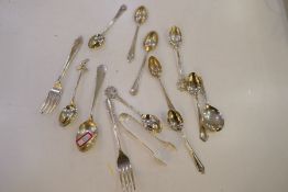 A quantity of silver flatware to include spoons, forks and tongs with various hallmarks. Also with t