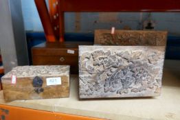 A set of wooden boxes some with inlaid lids, some with carved lids