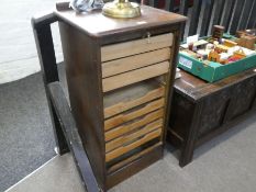 An oak filing cabinet having tambour door