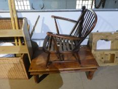 An Ercol stick back armchair and Indian oblong coffee table