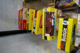 Four boxed Budgie die-cast vehicles and a boxed tinplate car