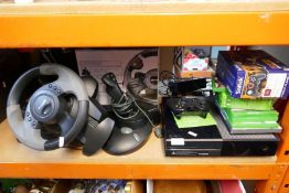 A selection of gaming equipment, including XBox one, games and various equipment