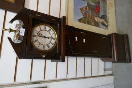 A wooden cased wind up Grandfather clock