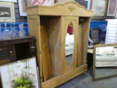 An old pine triple wardrobe having central mirrored door