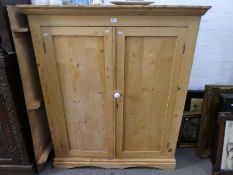 A stripped pine two door cupboard, 116cm