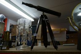 A brass and leather bound telescope on wood and brass bound tripod