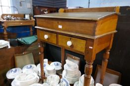 An old pine clerks desk having two drawers on turned legs