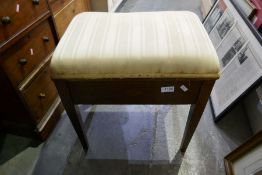 An Edwardian inlaid mahogany piano stool having rising lid and a Georgian