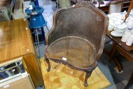 A French carved walnut armchair with cane seat and back, and a modern square coffee table with inlai