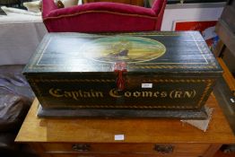 An old pine painted trunk. The lid decorated galleon bearing name Captain Coomes (R.N) with military
