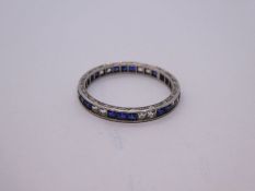White metal full eternity ring set with blue and white square cut chanel set sapphires with engraved