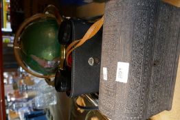 A vintage stationary box, binoculars and globe