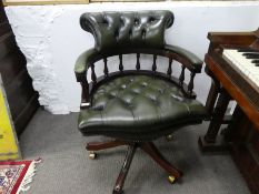 A reproduction green leather revolving desk chair