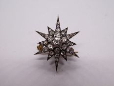 Victorian unmarked yellow metal brooch inset with approx 26 starburst various sized diamonds the cen
