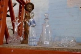 A selection of cut glass decanters, Lladro figure and a wooden figure