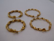 Two pairs of 9ct yellow gold twist design hoop earrings, the largest 2.5cm diameter, both marked 375