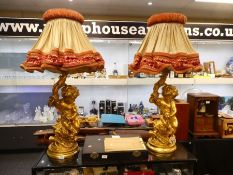 A pair of mid 20th century gilt plaster table lamps of cherub with handmade lampshades, lamp height