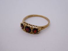 9ct yellow gold garnet ring, the mount framing the words 'with love' marked 375, size R/S