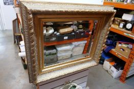 A deep framed bevelled edge mirror