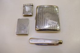 A silver cigarette case with central cartouche, hallmarked Birmingham 1916 Henry Matthews, also with