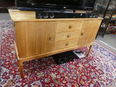 A late 1950's, Russell of Broadway sideboard having three central drawers with matching extending di