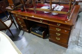 A large reproduction mahogany twin pedestal desk having nine drawers