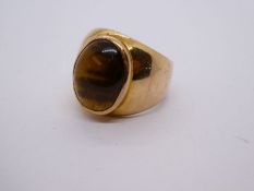 Unmarked yellow metal gents signet ring set large oval tiger's eye, size Z and I, gross 16.7g approx