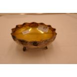 A Chinese silver dish with gilt bowl interior and scallop design rim. On three feet, stamped 25.5 oz