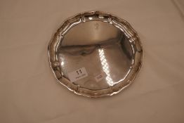 A silver salver of circular form with scalloped design rim with letter B engraved. 800 silver 7.17oz