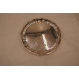 A silver salver of circular form with scalloped design rim with letter B engraved. 800 silver 7.17oz