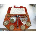 An antique probably early 19th century set of pocket weighing scales in fitted leather case with emb