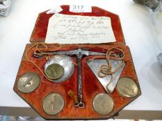 An antique probably early 19th century set of pocket weighing scales in fitted leather case with emb