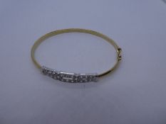 9ct yellow gold bangle with cubic zirconia art deco style panel, 6cm diameter; 6.2g approx